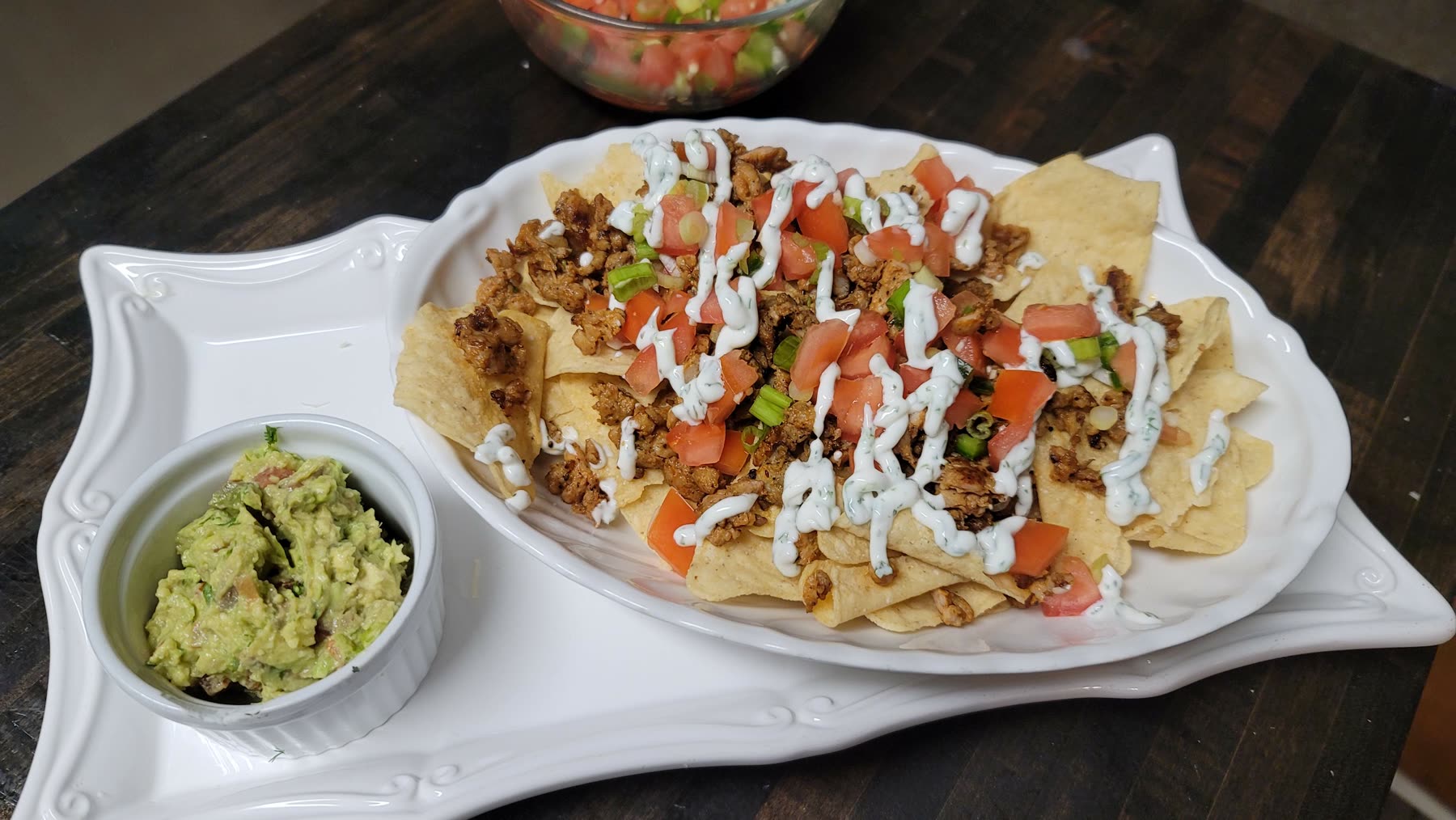 Loaded nachos topped with chicken sausage and pico de gallo