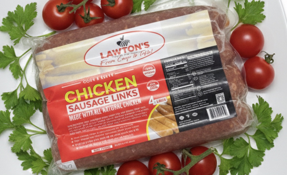 A pack of Lawton's chicken sausage links among tomatoes and parsley